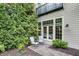 Outdoor patio with seating area next to a green wall at 6430 Meridian Pkwy # Apt A, Indianapolis, IN 46220