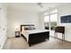 Cozy bedroom with a double bed, ceiling fan and window with pleasant exterior view at 6430 Meridian Pkwy # Apt A, Indianapolis, IN 46220