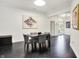 Modern dining room featuring a sleek table, stylish chairs, and chic black herringbone floors at 6430 Meridian Pkwy # Apt A, Indianapolis, IN 46220