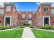 Brick townhome complex with manicured landscaping and a well-maintained walkway at 6430 Meridian Pkwy # Apt A, Indianapolis, IN 46220
