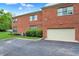 Exterior of a brick home showcasing a two-car garage and ample parking space at 6430 Meridian Pkwy # Apt A, Indianapolis, IN 46220