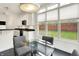 A breakfast nook with a kitchen in the background, featuring white cabinets, stainless appliances, and outdoor views at 6430 Meridian Pkwy # Apt A, Indianapolis, IN 46220