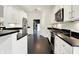 Stylish kitchen featuring white cabinets, black countertops, and stainless steel appliances at 6430 Meridian Pkwy # Apt A, Indianapolis, IN 46220