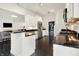 A bright kitchen features white cabinets, stainless steel appliances, and a black countertop and island at 6430 Meridian Pkwy # Apt A, Indianapolis, IN 46220