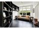 Stylish living room with built-in bookshelves and large windows overlooking the backyard at 6430 Meridian Pkwy # Apt A, Indianapolis, IN 46220
