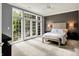 A bedroom with carpet, neutral tones, and double doors that provide lots of natural light at 6430 Meridian Pkwy # Apt A, Indianapolis, IN 46220