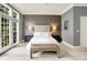 A main bedroom with decorative walls, ample natural light and neutral carpet and decor at 6430 Meridian Pkwy # Apt A, Indianapolis, IN 46220