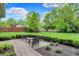 Paver patio with outdoor seating and a well-manicured lawn and garden at 6430 Meridian Pkwy # Apt A, Indianapolis, IN 46220