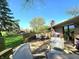 Outdoor patio with a dining table, seating, and a lush green lawn at 6723 Balmoral Rd, Indianapolis, IN 46241
