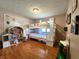 bedroom with bunk beds, dollhouse, wood floors, and hot air balloon wallpaper at 6723 Balmoral Rd, Indianapolis, IN 46241