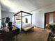 Bright bedroom with a four-poster bed, carpet, desk and natural light at 6723 Balmoral Rd, Indianapolis, IN 46241