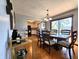 Inviting dining room with hardwood floors, modern lighting, and sliding doors leading to the yard at 6723 Balmoral Rd, Indianapolis, IN 46241