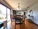 Open dining room with hardwood floors, modern chandelier, sliding glass doors, and connections to other living areas at 6723 Balmoral Rd, Indianapolis, IN 46241