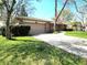 Charming single-story brick home with a two-car garage and well-maintained landscaping and a concrete driveway at 6723 Balmoral Rd, Indianapolis, IN 46241