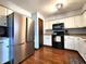 Functional kitchen with stainless steel appliances, white cabinets, and wood flooring at 6723 Balmoral Rd, Indianapolis, IN 46241