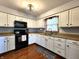 Bright kitchen featuring white cabinets, dark appliances, and laminate counters at 6723 Balmoral Rd, Indianapolis, IN 46241
