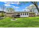 Lush green backyard with a patio, firepit, and outdoor furniture at 6826 Hague Rd, Indianapolis, IN 46256