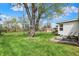 Spacious backyard with a lush lawn, mature trees, and a tranquil seating area, perfect for outdoor enjoyment at 6826 Hague Rd, Indianapolis, IN 46256