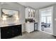 Stylish bar area with elegant cabinet, mini fridge, and a chic black console table at 6826 Hague Rd, Indianapolis, IN 46256