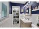 Bright bathroom with white subway tiles, a vanity, and a window for natural light, plus an organized closet at 6826 Hague Rd, Indianapolis, IN 46256