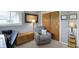 Relaxing bedroom features a soft armchair, wooden storage chest, and a neutral color palette at 6826 Hague Rd, Indianapolis, IN 46256