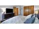 Comfortable bedroom featuring a dresser, closet, and soft bedding for a peaceful night's sleep at 6826 Hague Rd, Indianapolis, IN 46256