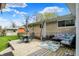 Outdoor deck with a dining set, lounge furniture, and a stone-accented exterior, ideal for relaxation and entertaining at 6826 Hague Rd, Indianapolis, IN 46256