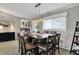A dining room has a wooden table and decor beneath a chandelier, as well as a built-in bar against the wall at 6826 Hague Rd, Indianapolis, IN 46256