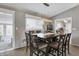 An airy dining room shows a wooden dining table, decor, chandelier and light filtering through the window at 6826 Hague Rd, Indianapolis, IN 46256