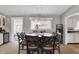Cozy dining room with a wooden table, seating for eight, and modern lighting at 6826 Hague Rd, Indianapolis, IN 46256