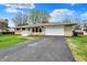 Well-maintained single-story home with stone exterior, attached garage, and driveway at 6826 Hague Rd, Indianapolis, IN 46256