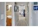 Inviting hallway featuring neutral walls, carpet, and convenient access to the bathroom and living areas at 6826 Hague Rd, Indianapolis, IN 46256