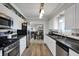 Updated kitchen with black countertops, stainless steel appliances, and light wood flooring at 6826 Hague Rd, Indianapolis, IN 46256