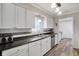 Bright kitchen featuring white cabinets, stainless steel appliances, and modern backsplash at 6826 Hague Rd, Indianapolis, IN 46256