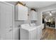 Well-equipped laundry room with appliances, white cabinets, and easy access to outdoor space at 6826 Hague Rd, Indianapolis, IN 46256