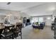 Open concept living room and dining room with vaulted ceiling, blue sofa and contemporary furnishings at 6826 Hague Rd, Indianapolis, IN 46256