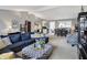 Open-concept living room with modern decor and comfortable seating, adjacent to the dining area at 6826 Hague Rd, Indianapolis, IN 46256