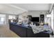Bright open concept living room featuring comfortable seating, a television, and open access to the kitchen at 6826 Hague Rd, Indianapolis, IN 46256
