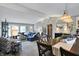 Expansive living area with a blue sectional sofa, open to the dining room, offering plenty of space for entertaining at 6826 Hague Rd, Indianapolis, IN 46256