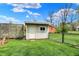 Outdoor storage shed on a green lawn with chain link fence at 6826 Hague Rd, Indianapolis, IN 46256
