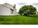 Large, manicured backyard with mature tree in a suburban setting at 7131 Topp Creek Ct, Indianapolis, IN 46214