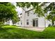 Back of home showing the patio and yard with mature trees at 7131 Topp Creek Ct, Indianapolis, IN 46214