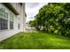 Lush backyard featuring a well-maintained lawn and shade trees with white picket fence at 7131 Topp Creek Ct, Indianapolis, IN 46214