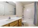 Well-lit bathroom featuring a vanity, toilet, and shower with a shower curtain at 7131 Topp Creek Ct, Indianapolis, IN 46214