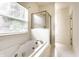 Relax in this bathroom with a large tub and a separate shower, complemented by a window view at 7131 Topp Creek Ct, Indianapolis, IN 46214