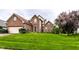 Charming two-story brick home with lush green front lawn, offering an inviting curb appeal at 7131 Topp Creek Ct, Indianapolis, IN 46214