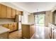 Well-appointed kitchen with wood cabinets, white appliances, island and view of outdoor patio at 7131 Topp Creek Ct, Indianapolis, IN 46214