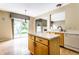 Open kitchen with island, white countertops, stainless steel appliances, and natural lighting at 7131 Topp Creek Ct, Indianapolis, IN 46214