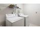 Laundry room with a washing machine, dryer, and overhead shelving for organized storage at 7131 Topp Creek Ct, Indianapolis, IN 46214