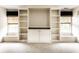 Bright living room has custom built-in shelves and storage, plus natural light from two windows at 7131 Topp Creek Ct, Indianapolis, IN 46214